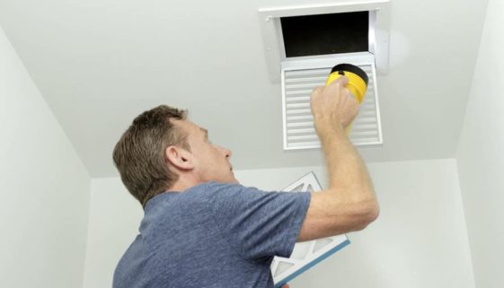 man cleaning air ducts
