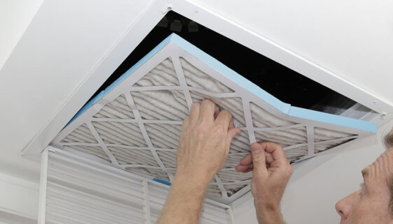 Closeup of a Man Replacing an Air Filter in a Home How Do You Keep Your Ducts Clean